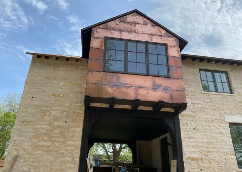 Copper metal panel facade on a stone building for Skylight Installation in Fair Oaks